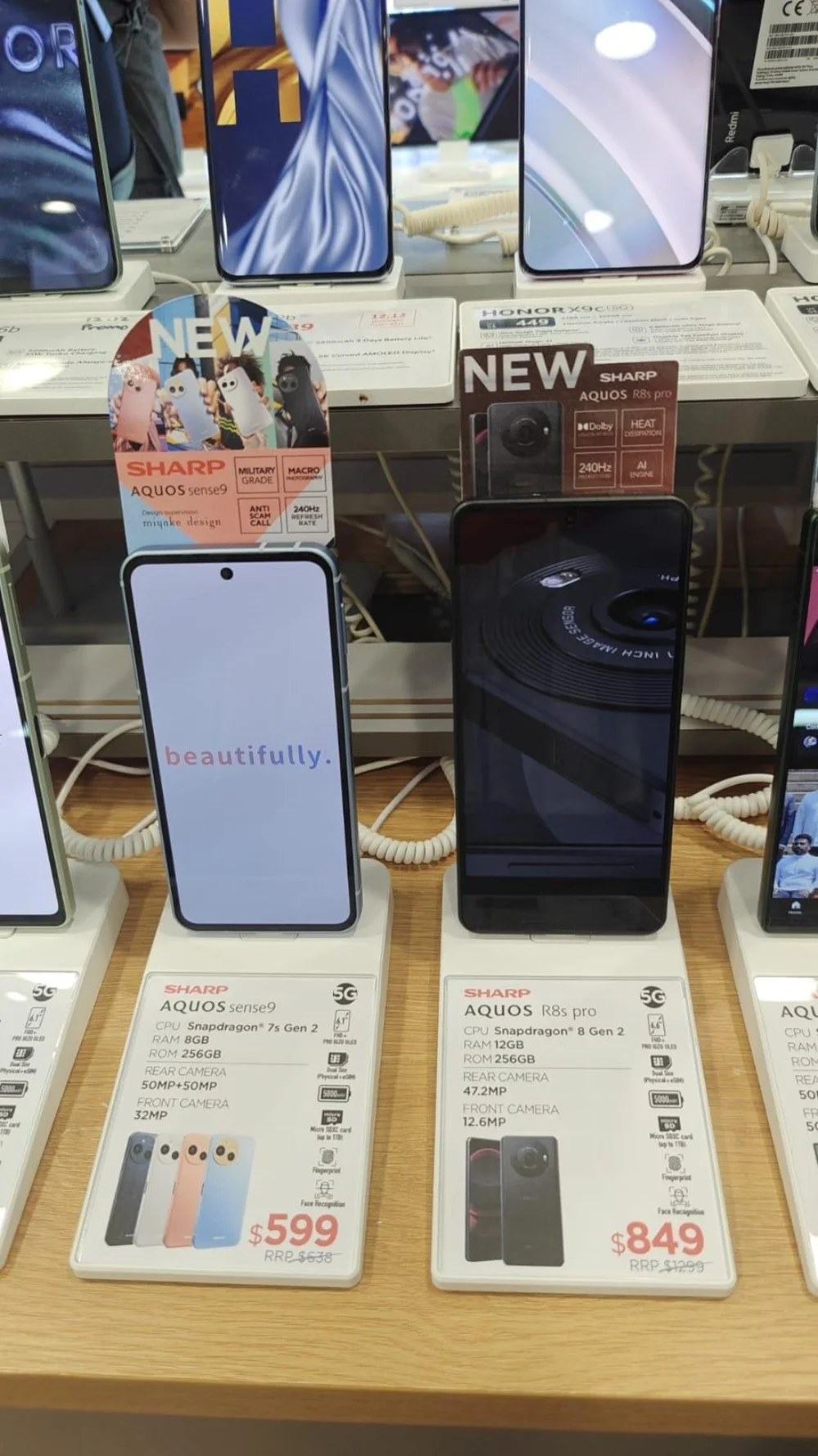 Close view of Sharp AQUOS phones and integrated PA-07 price cards